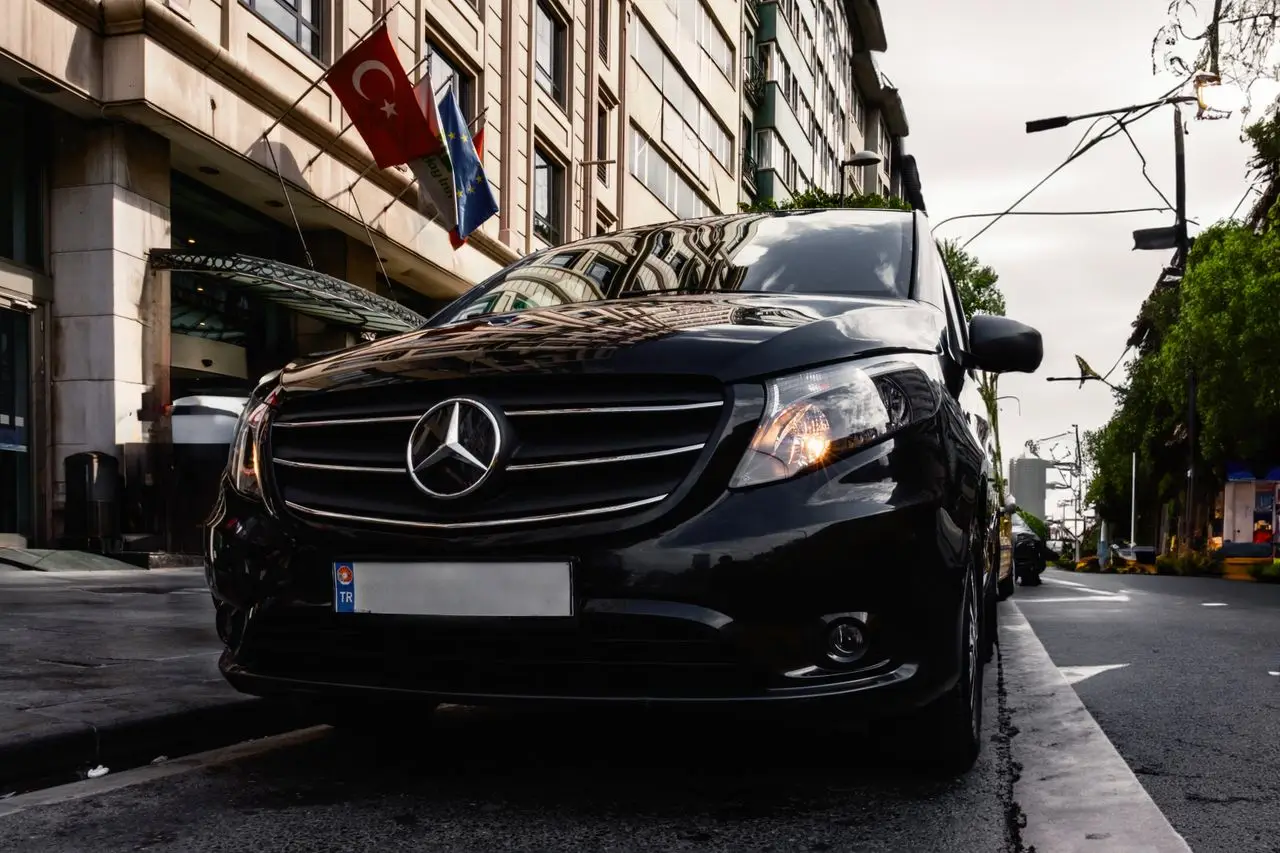 services-01 Luxury black Mercedes-Benz Vito parked on a Turkish city street, capturing urban elegance.
